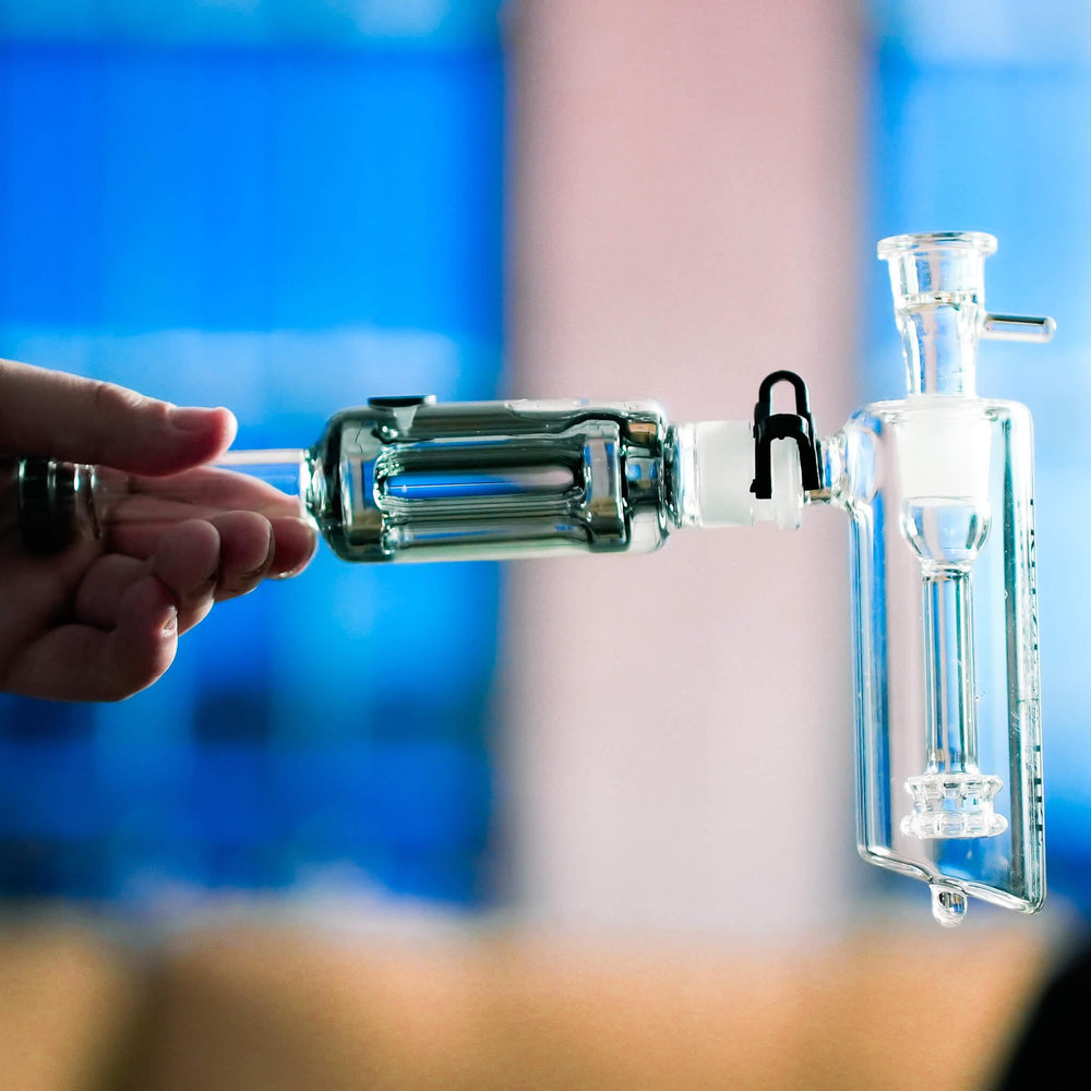 Holding a Bubbler Pro, showing the Revolver Coil and the double showerhead perc